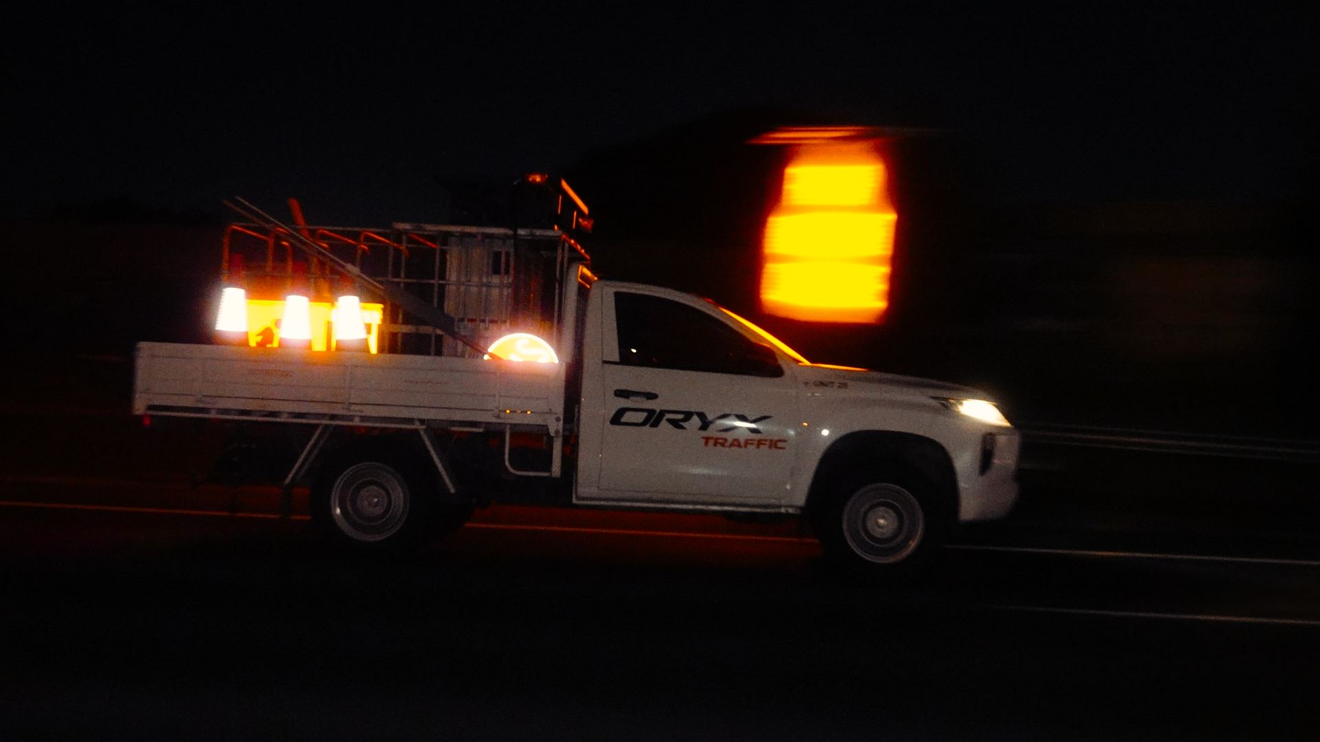 Traffic management equipment including arrow boards and cones at night